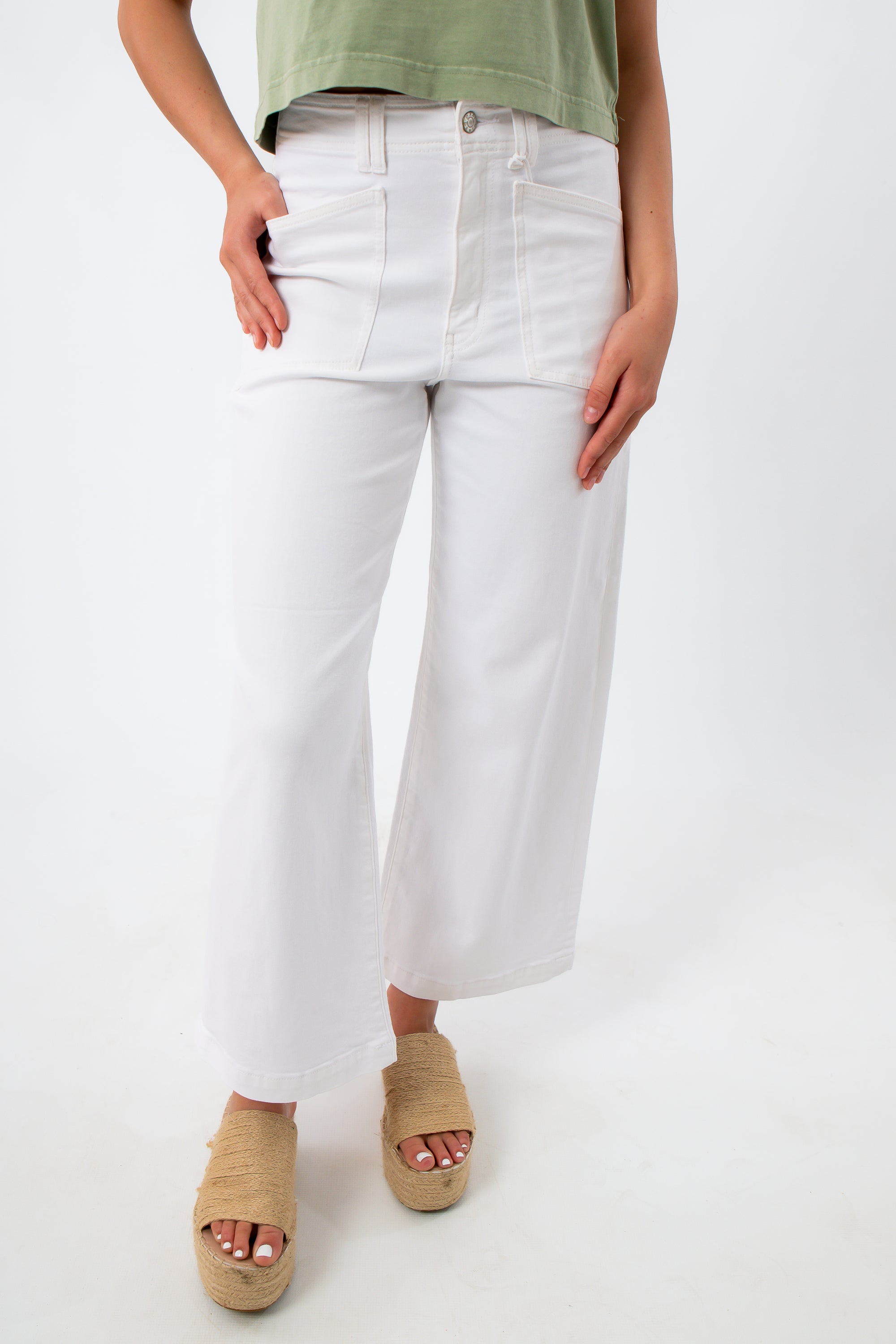 Close-up of white high-waisted denim jeans with front pockets and belt loops