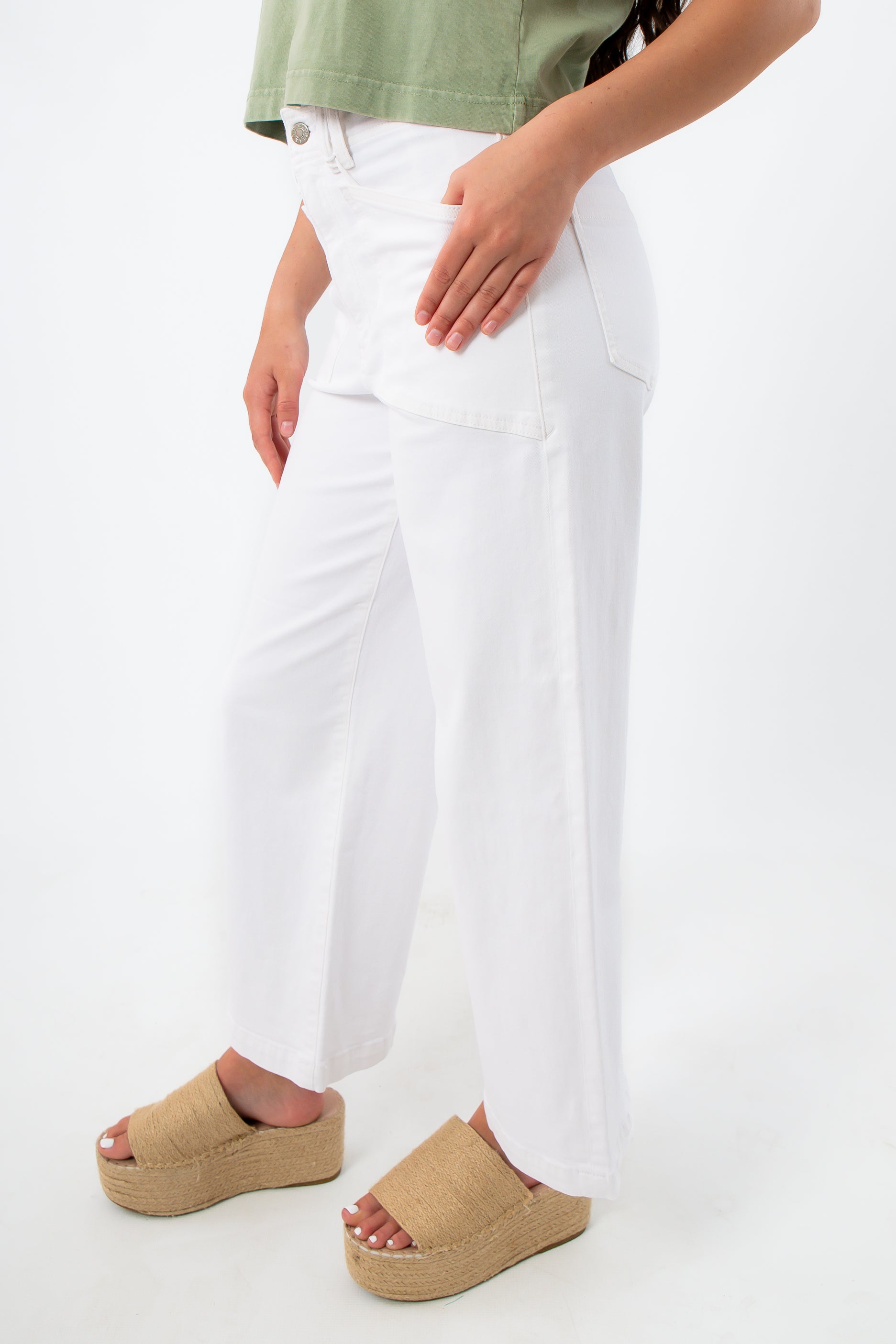 Back view of white wide-leg denim jeans with back pockets and model in green top