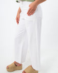 Back view of white wide-leg denim jeans with back pockets and model in green top