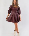 Bordeaux Bliss Faux Leather Dress with puff sleeves and flared skirt, styled for holiday parties or gameday looks in rich wine red.