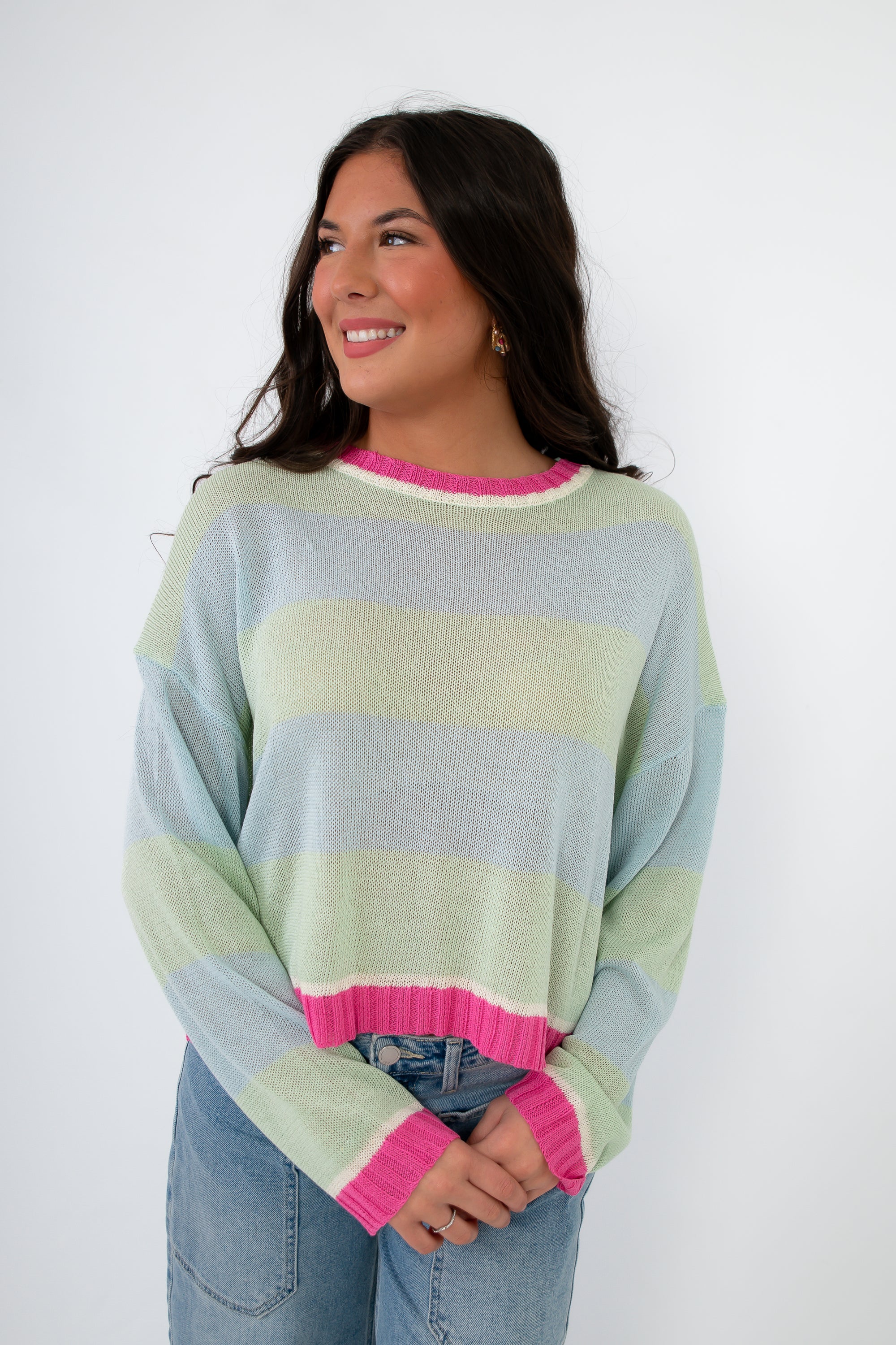 Women’s Cabana Stripe Lightweight Sweater featuring pastel mint and sky blue stripes with pink accents, paired with high-rise jeans. Soft spring knit top.