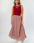 Versatile Wine & Dine Rib Sleeveless Sweater paired with a checkered maxi skirt, perfect for gameday or casual fall outings.