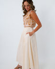 Cream midi skirt with side pockets paired with a seashell printed sleeveless top for the perfect summer workwear look