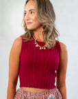 Wine & Dine Sleeveless Sweater in ribbed knit with a flattering fit, styled with a gingham skirt for a chic fall-ready look.