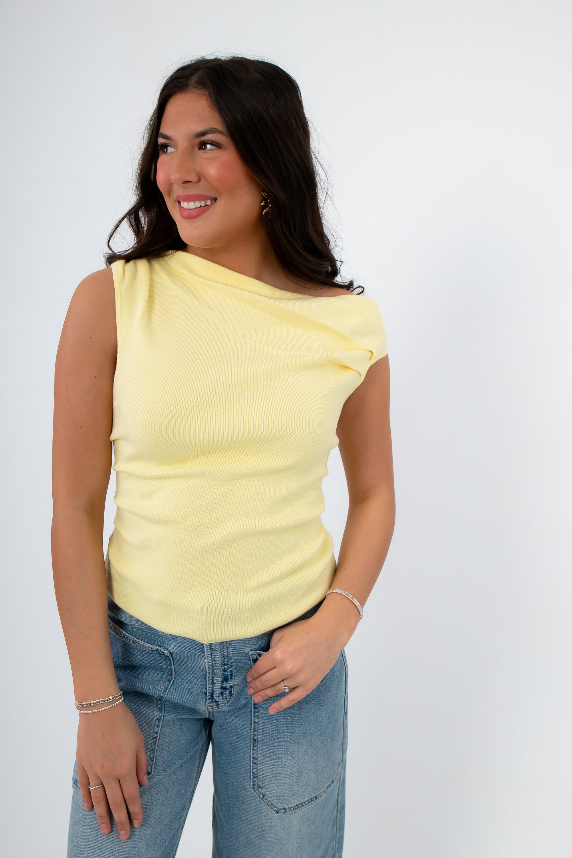 Model wearing Friday Feeling Butter Yellow Asymmetrical Knit Top with ruched neckline. Breathable and stylish spring knit tank top for women.