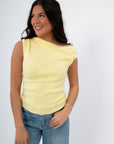 Model wearing Friday Feeling Butter Yellow Asymmetrical Knit Top with ruched neckline. Breathable and stylish spring knit tank top for women.