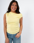 Close-up of Friday Feeling Butter Yellow Asymmetrical Knit Top featuring soft knit texture and flattering neckline. Ideal spring basic tank top.