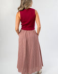 Back view of Wine & Dine Rib Sleeveless Sweater showing ribbed texture and cropped fit, paired with a gingham skirt for a stylish outfit.