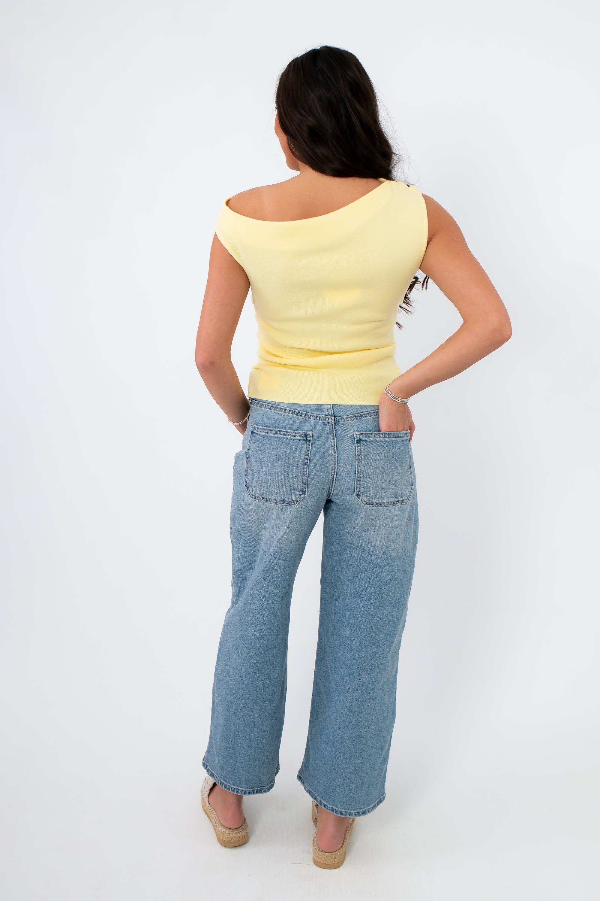 Back view of Friday Feeling Butter Yellow Asymmetrical Knit Top showing off-shoulder design. Chic and comfortable spring knit tank top.