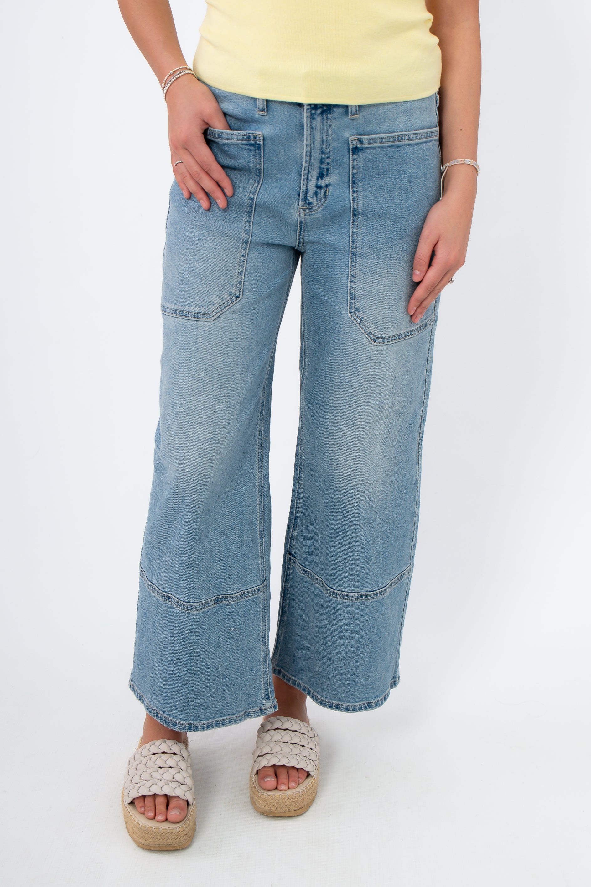 Kimberly Light Denim Cropped Wide Leg Jean with utility front pockets and high-rise fit, styled with espadrille sandals for casual wear.