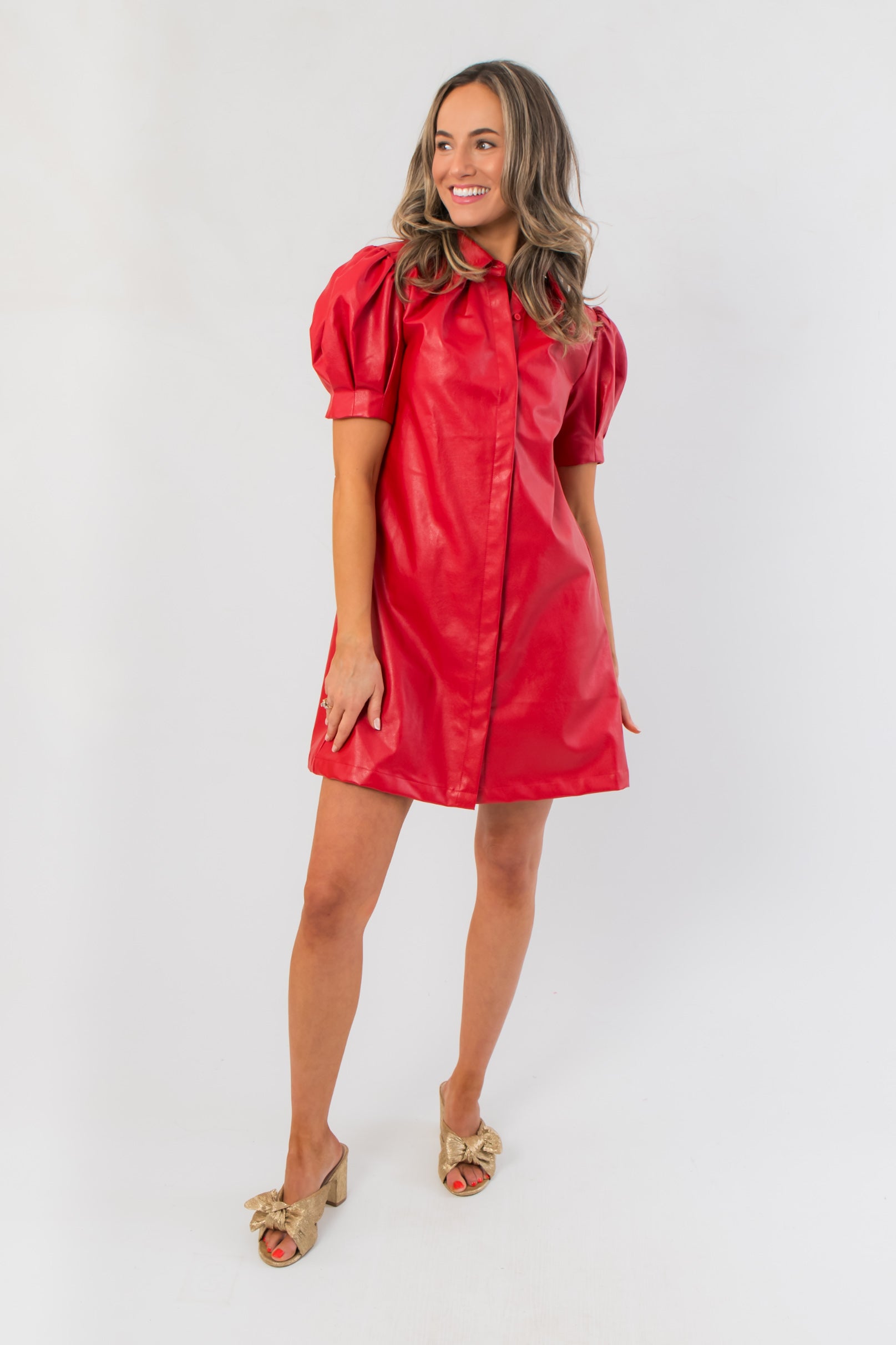 Sugarplum Showgirl Red Faux Leather Mini Dress with puff sleeves and front seam detail, ideal for holiday parties or festive occasions.