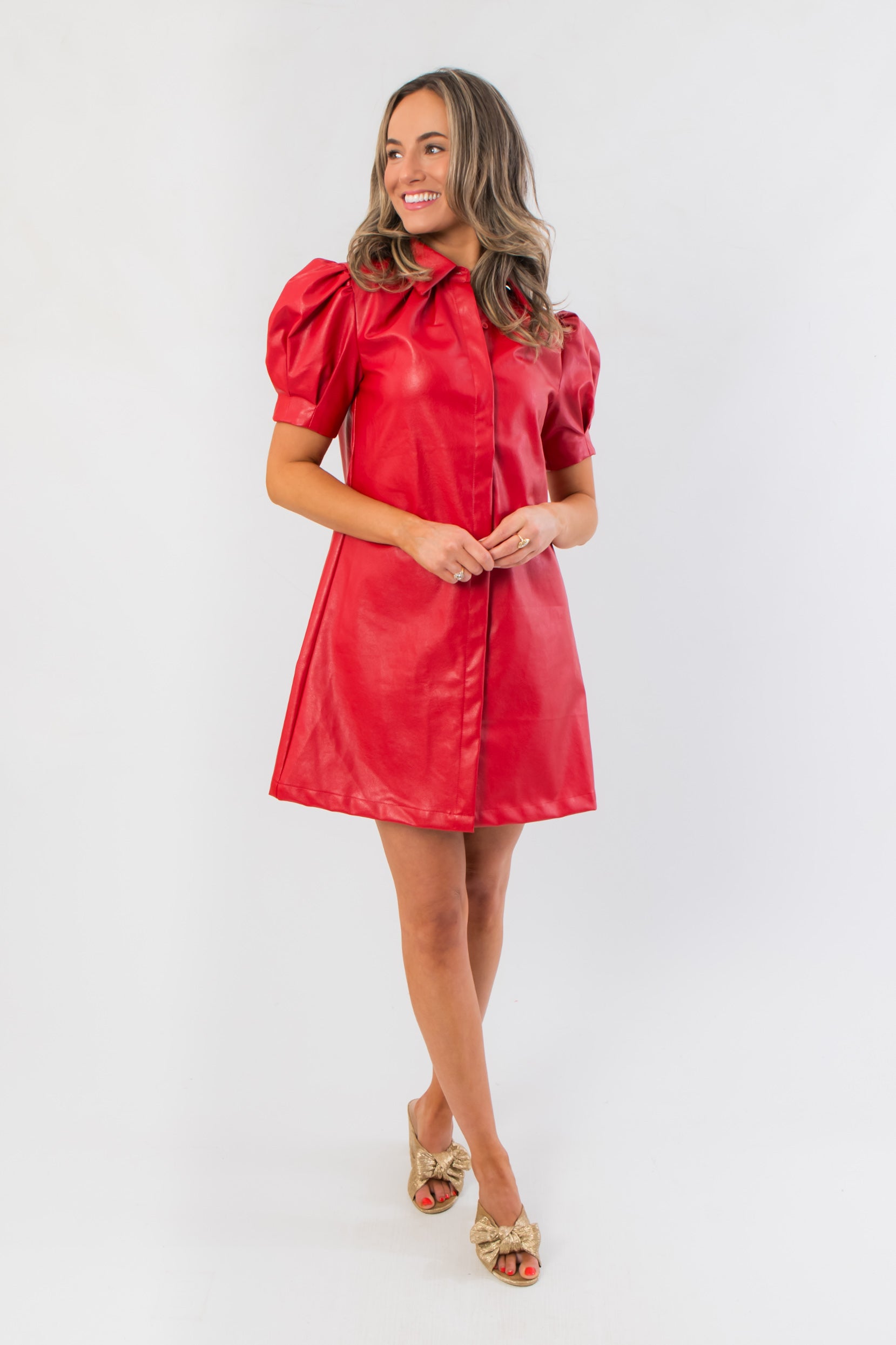 Vegan-friendly Sugarplum Showgirl Red Faux Leather Mini Dress featuring a short hemline and structured silhouette, perfect for statement holiday looks.