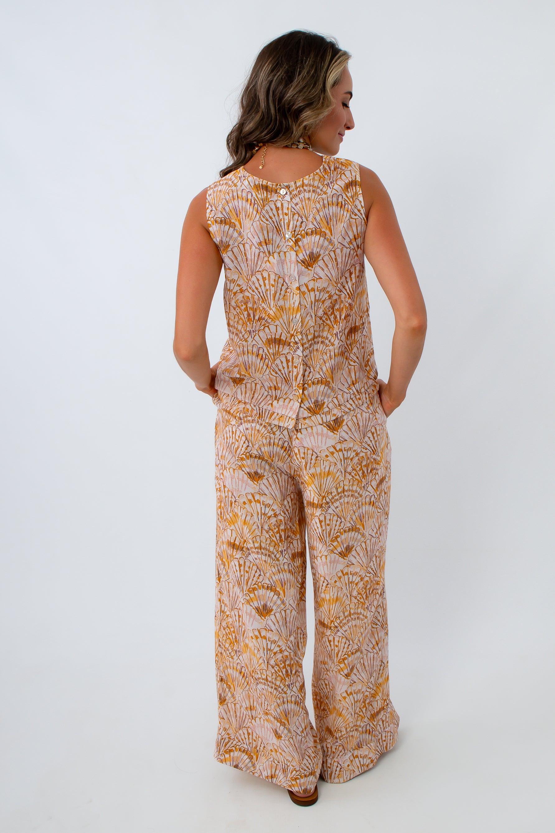 Yellow and orange seashell print pants with matching tank for a matching coastal set for vacation, summer, dinner outfit
