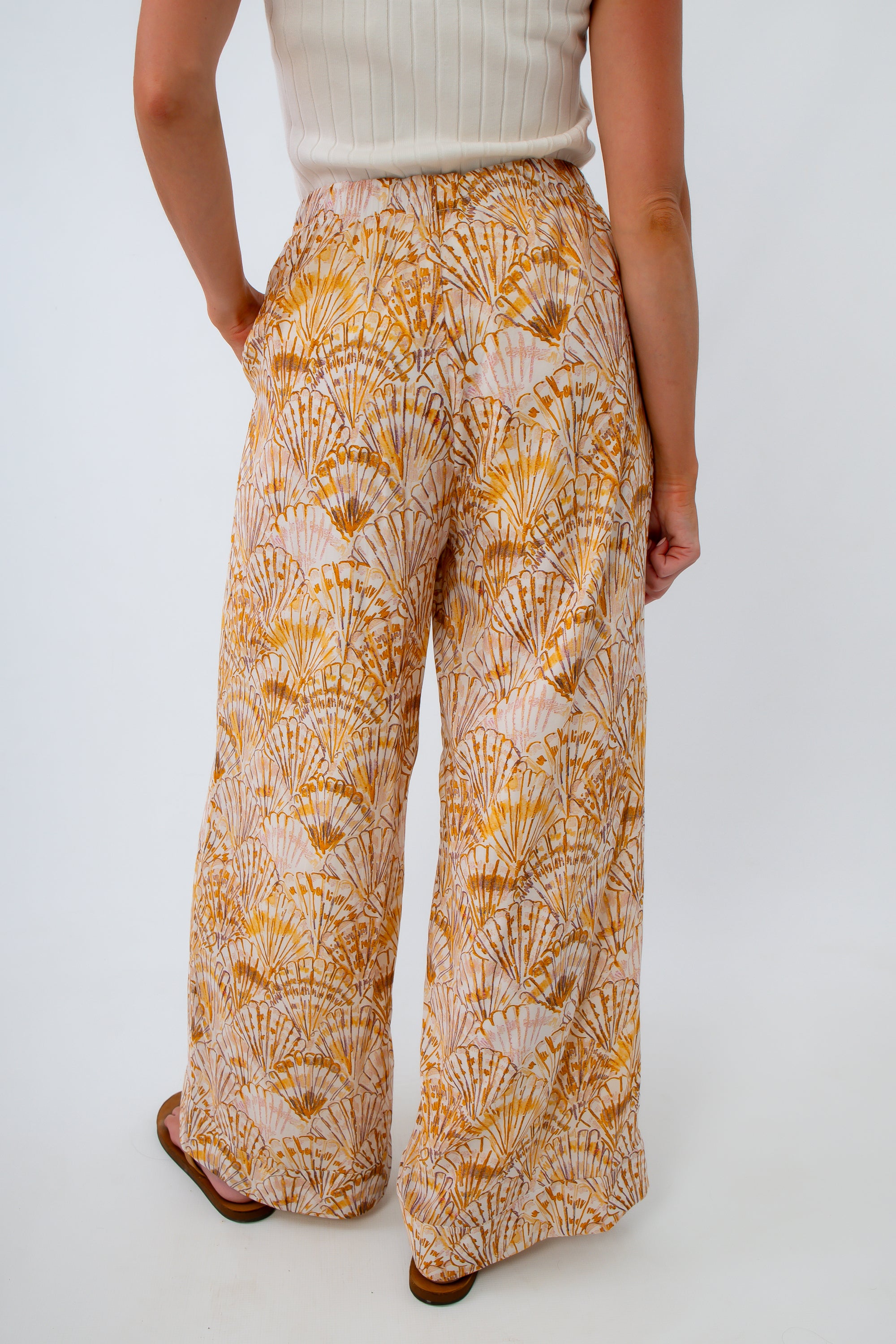 Full length lined beach trousers with scallop seashell print, in golden hour colors for vacation