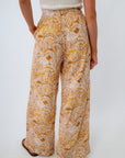Full length lined beach trousers with scallop seashell print, in golden hour colors for vacation
