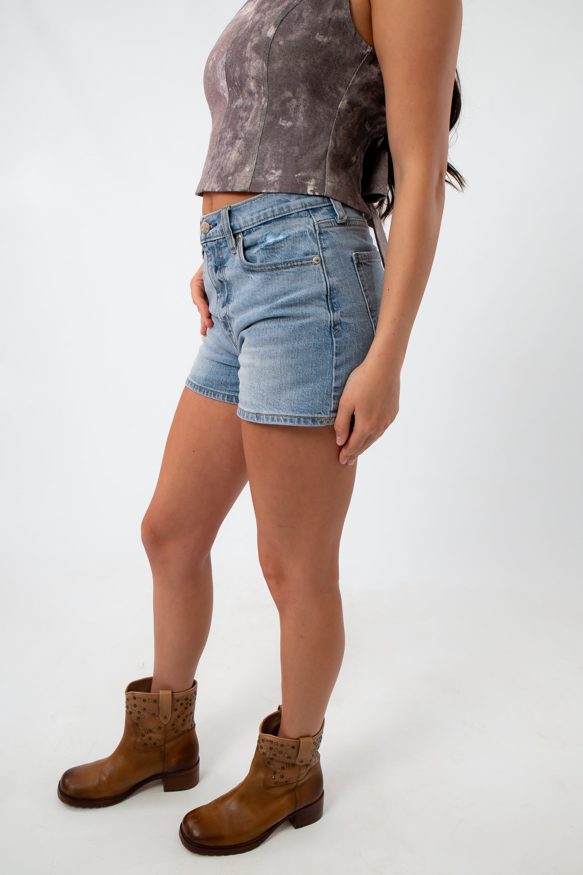 Back view of model in vintage wash denim shorts with high waist