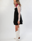 Side view of Black Bubble Hem Mini Dress showing flared silhouette and mesh sleeve detail, perfect for chic and playful occasions.