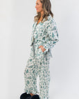 Side profile of Heritage Holiday Toile Green Pajama Set showing soft fabric, ribbon sleeve ties, and holiday toile pattern for stylish comfort.