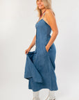 Side view of Z Supply Indigo Angel Eyes Denim Midi Dress showing adjustable straps, side pockets, and lightweight denim fabric.