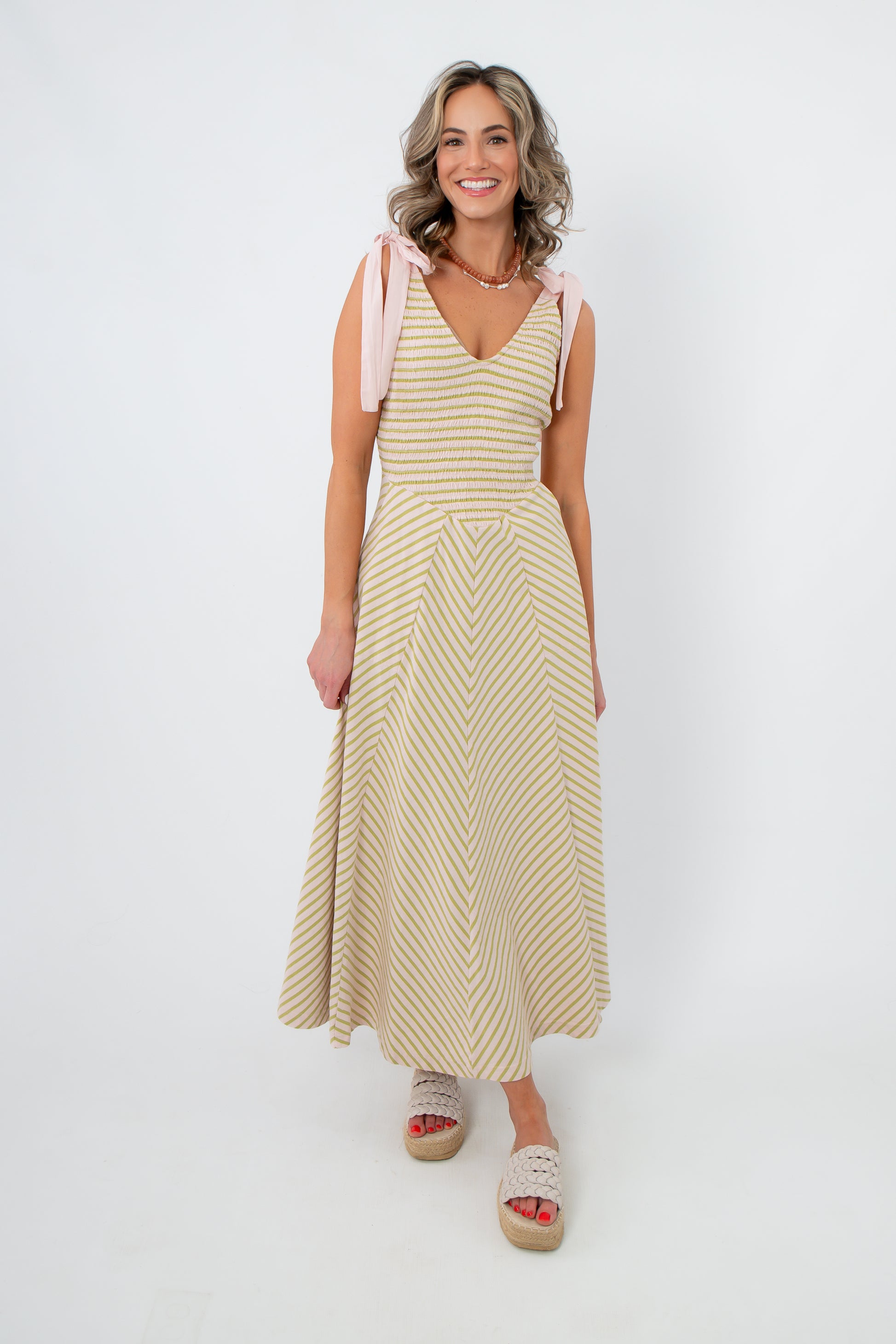 Effortless boho style Free People Palma Cecelia Midi Dress with pink tie straps and chevron stripes, perfect for weddings or casual outings.