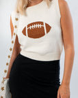 Close-up of Game Time Bedazzled Football Sleeveless Sweater featuring a sparkling rhinestone football design on white knit fabric.