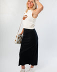 Sleeveless Game Time Football Sweater paired with star-accented bag and black skirt, ideal for casual gameday fashion.