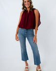 Fashionable fall blouse for women that features a bubble hem and dramatic cape sleeves for fall date night