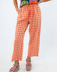 Candy Aisle Poppy gingham pants with varsity stripes, orange gingham pants with varsity stripe down the side