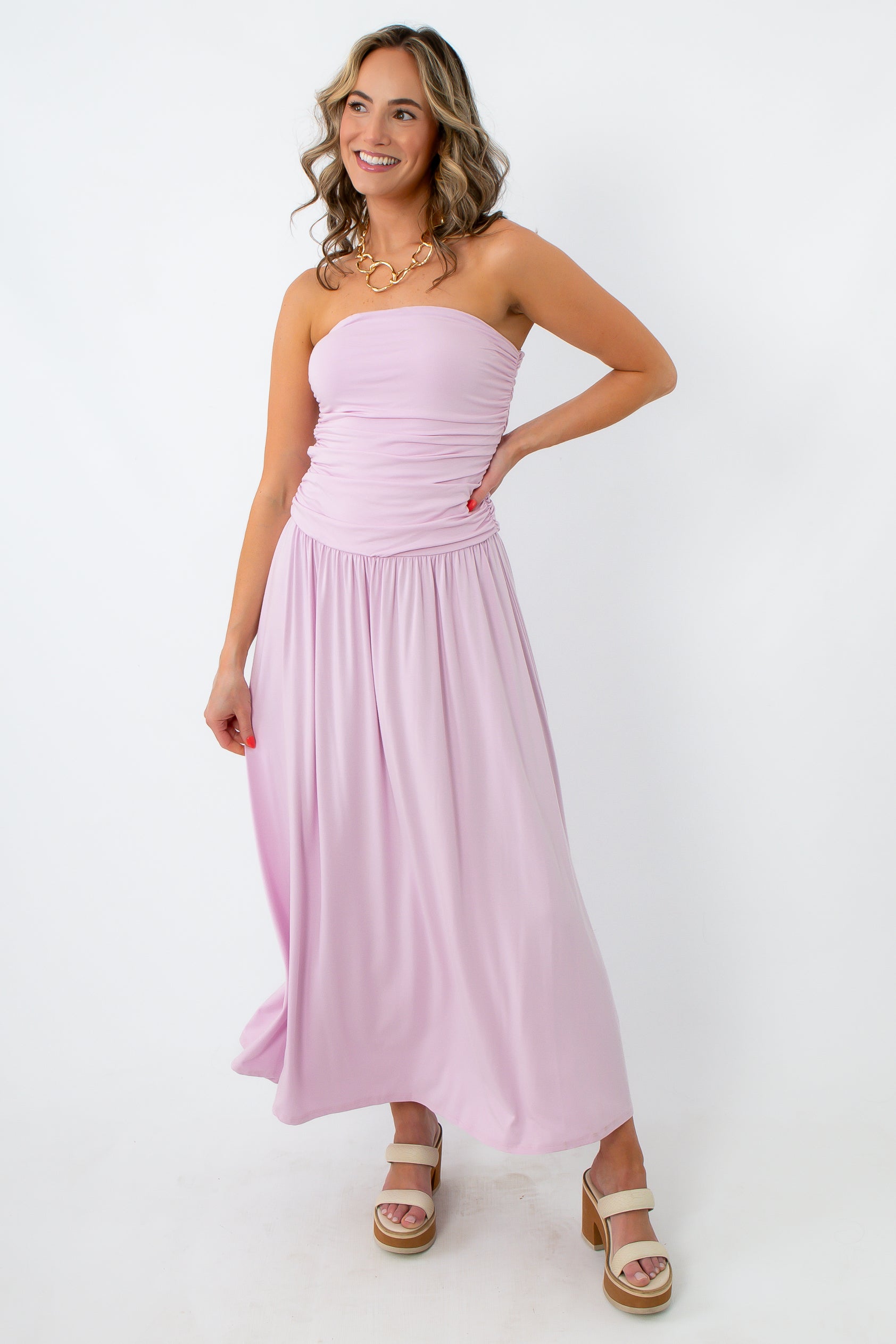 Side view of lilac ruched strapless maxi dress with flowy skirt for summer events