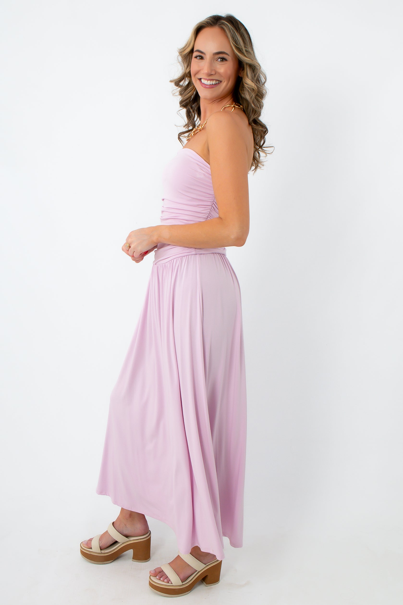 Model wearing lilac goddess strapless ruched maxi dress with chunky heels