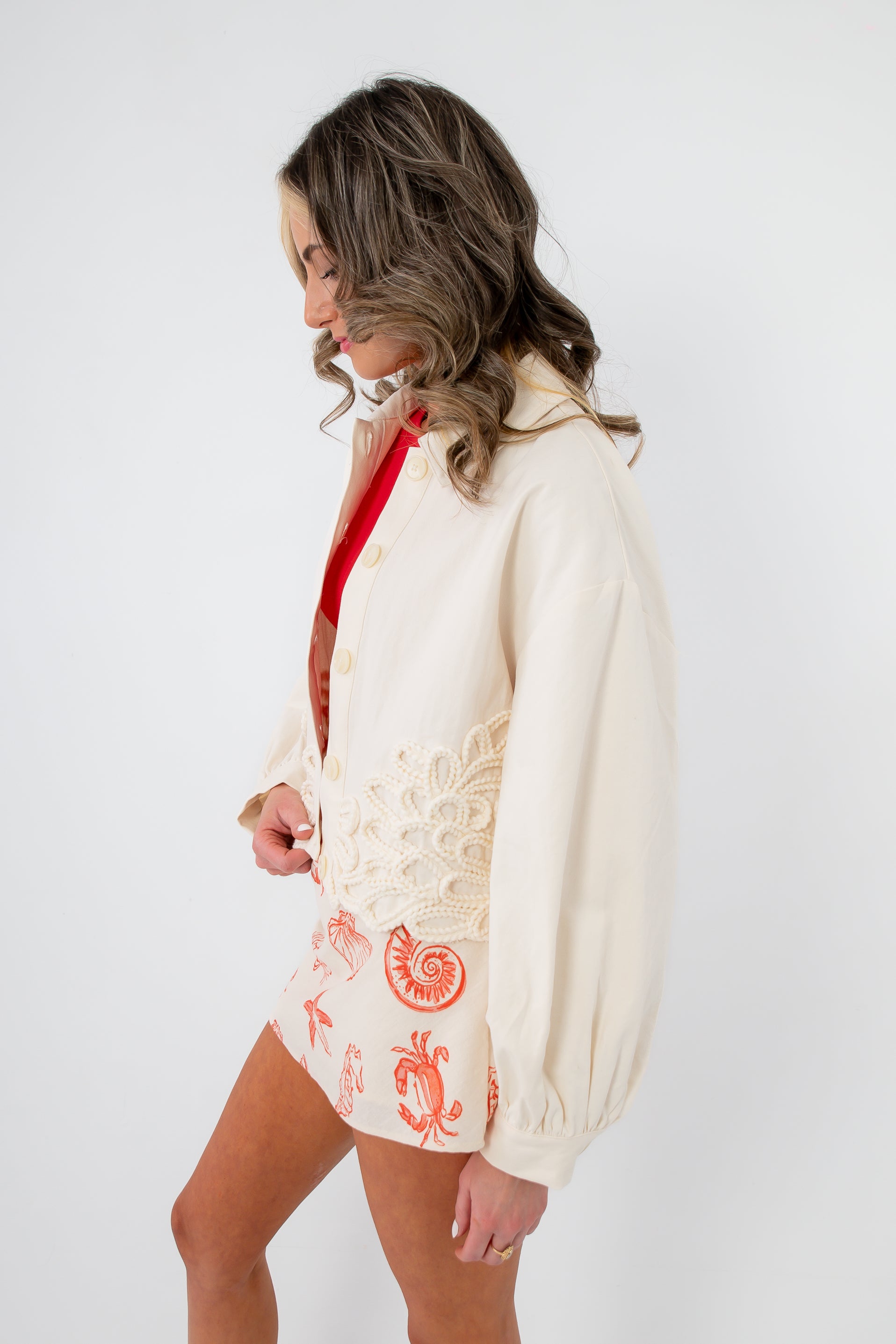 Side view of Seagarden Appliqué Floral Detail Jacket in ecru, showcasing floral appliqué and relaxed fit, perfect for spring layering.