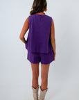 Purple cotton sleeveless denim shirt and matching purple cotton denim shorts for monochromatic game day look