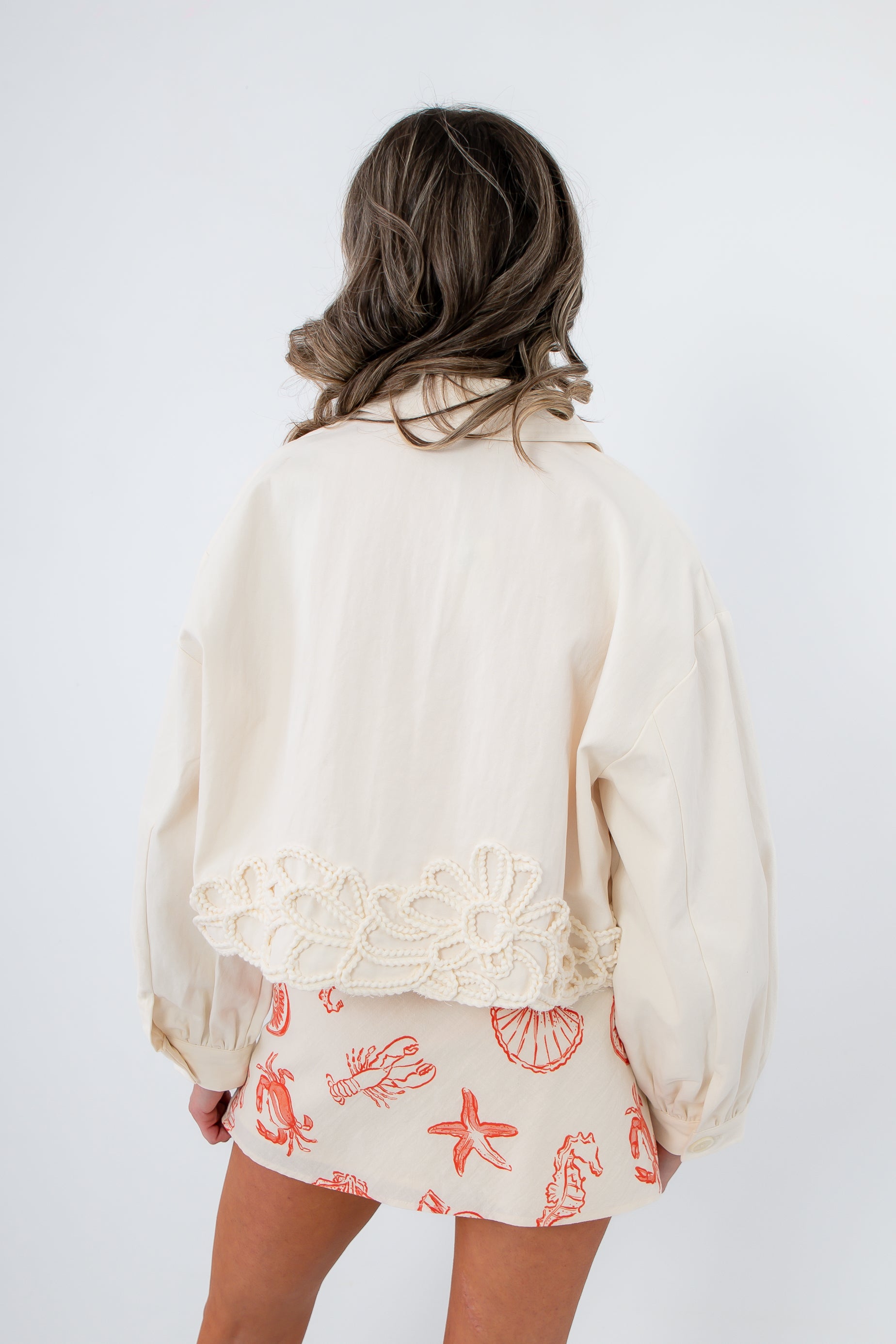 Seagarden Appliqué Floral Detail Jacket in ecru with intricate floral appliqué along the back hem, ideal lightweight spring outerwear for women.