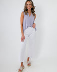 Full view of Lavender Mist V-Neck Sleeveless Drape Top paired with white wide-leg pants and woven sandals, perfect for spring outfits.