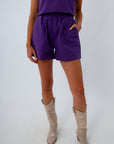 Purple denim shorts with coordinating purple denim top for cohesive game day look