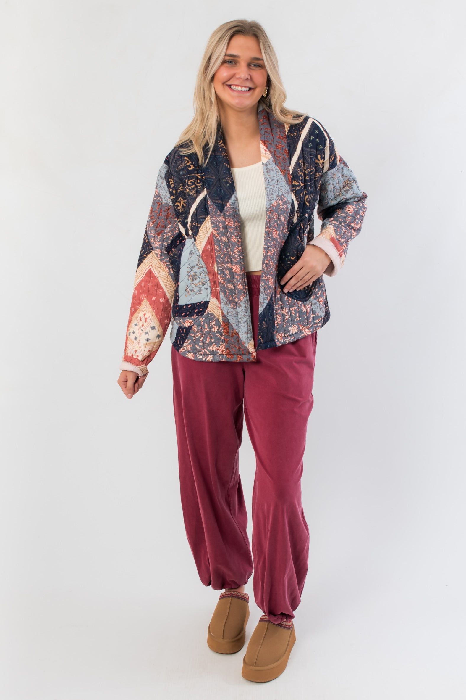 Navy and red Augusta Patchwork Quilted Jacket paired with burgundy pants, showcasing its casual fit and autumn-ready patchwork design.