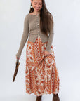 Burnt Orange Floral Patterned Midi Skirt styled with taupe ribbed cardigan and brown boots. Perfect fall style for casual outings.