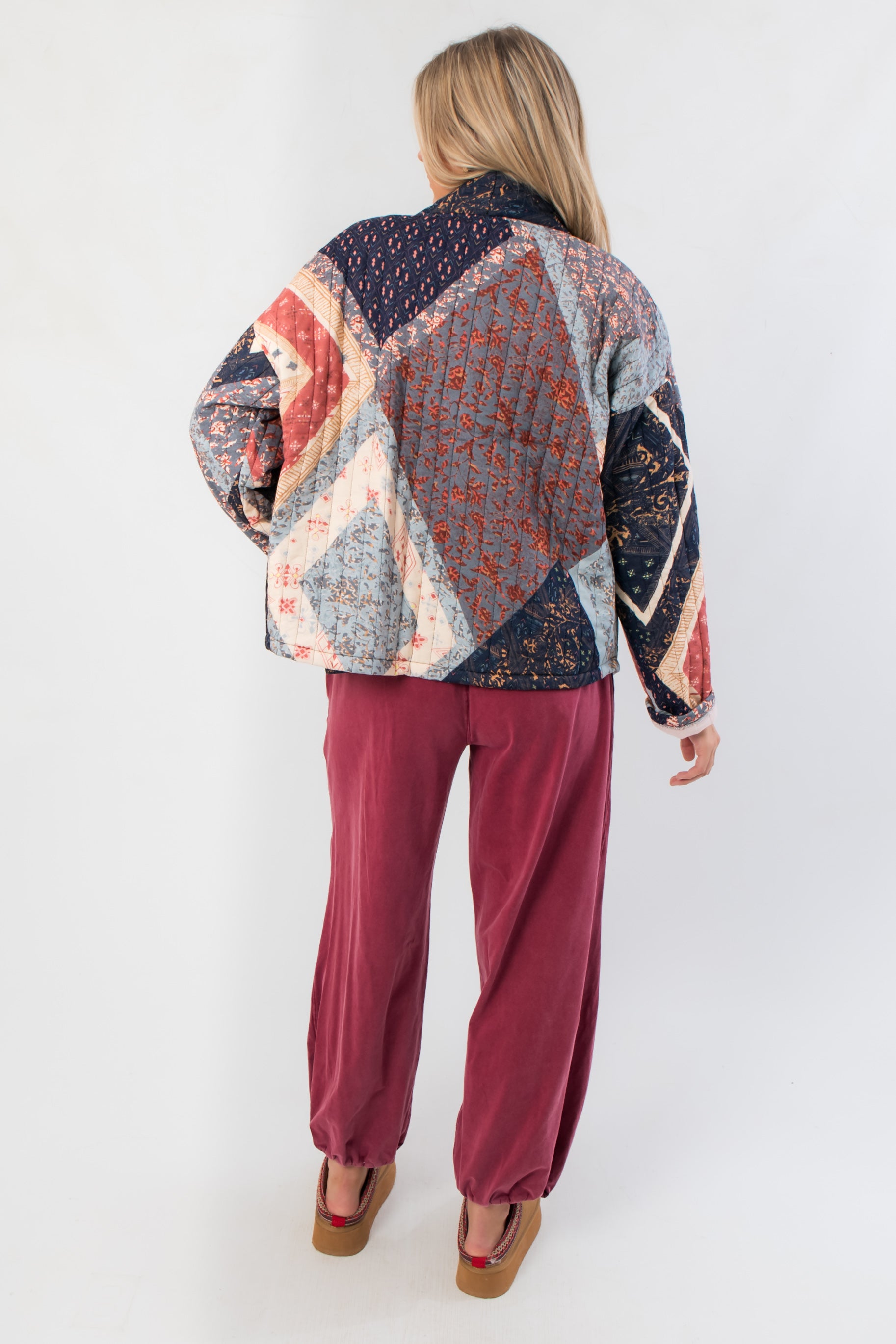 Back view of Augusta Patchwork Quilted Jacket featuring intricate navy and red patchwork design, ideal for fall and winter layering.