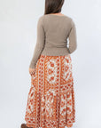 Back view of Burnt Orange Floral Patterned Midi Skirt showing flowy silhouette and detailed floral print. Great for fall wardrobes.