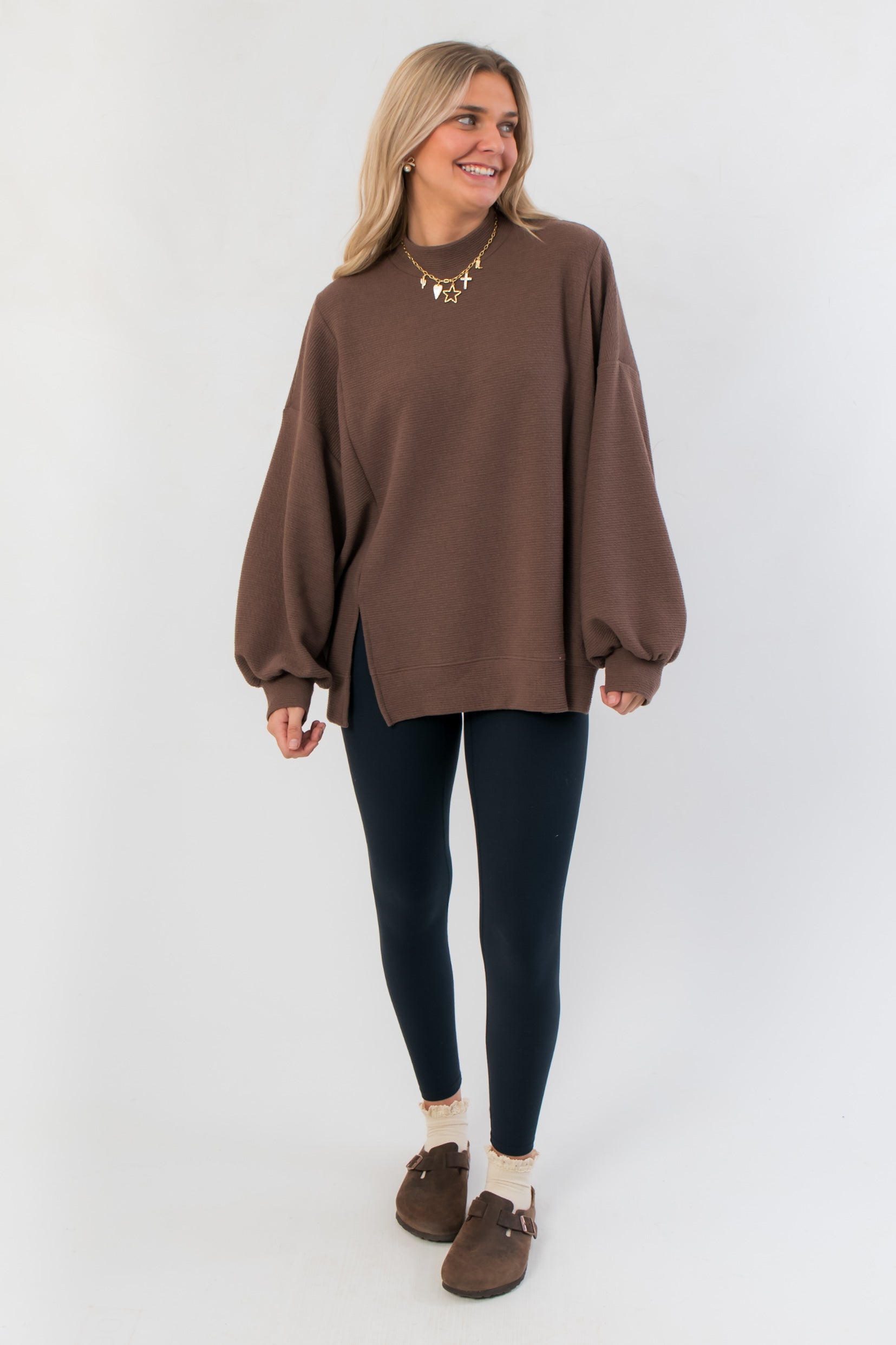 Front view of Camden Brown Ribbed Knit Mockneck Top featuring relaxed silhouette and side slit, ideal for casual layering.