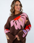 Oversized cropped fall sweater with intarsia floral pattern, brown sweater with pink flowers all over it, brown floral sweater