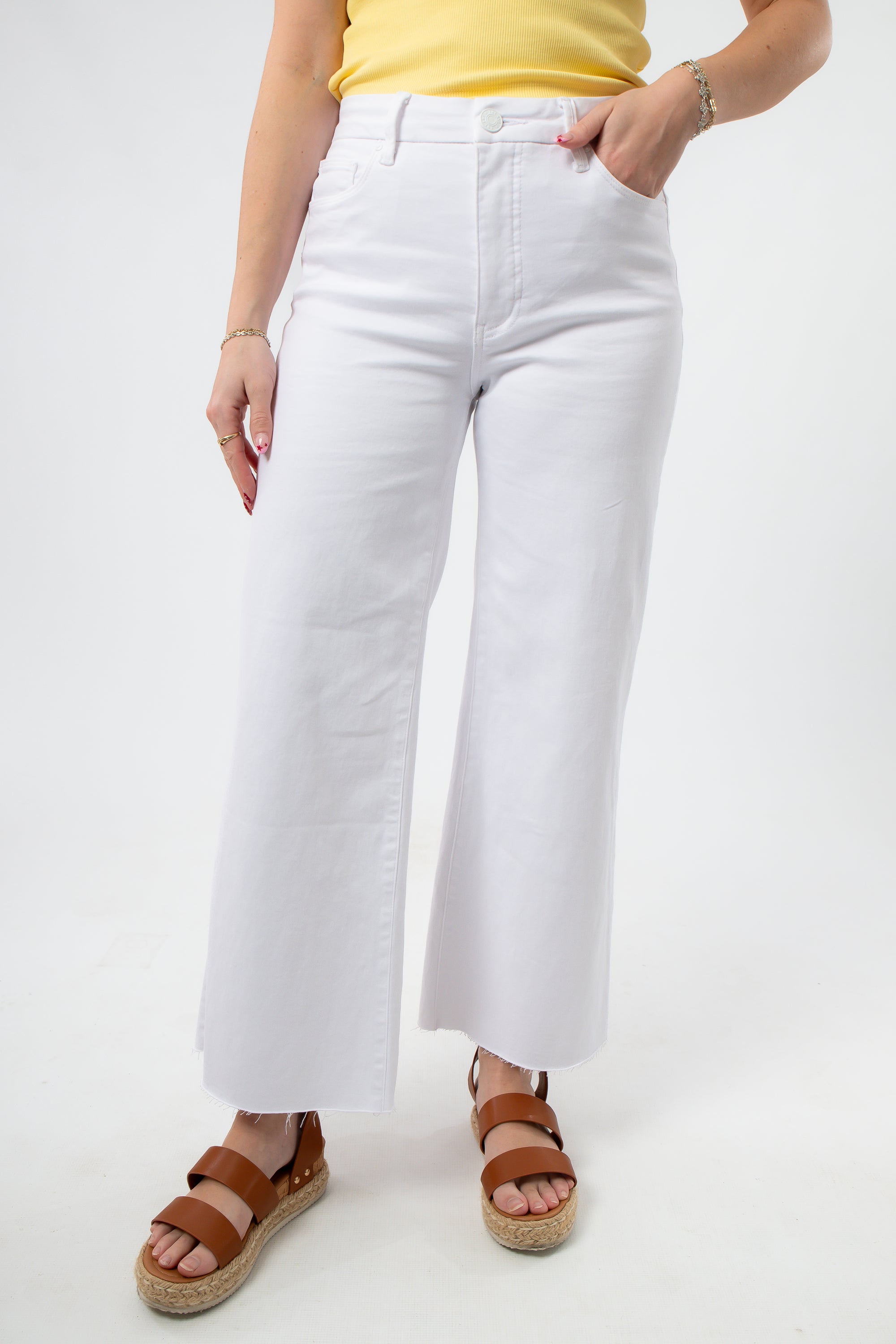 Kut from the Kloth Optic White Meg High Rise Wide Jean with raw hem, styled with tan espadrille sandals. Best selling summer denim.