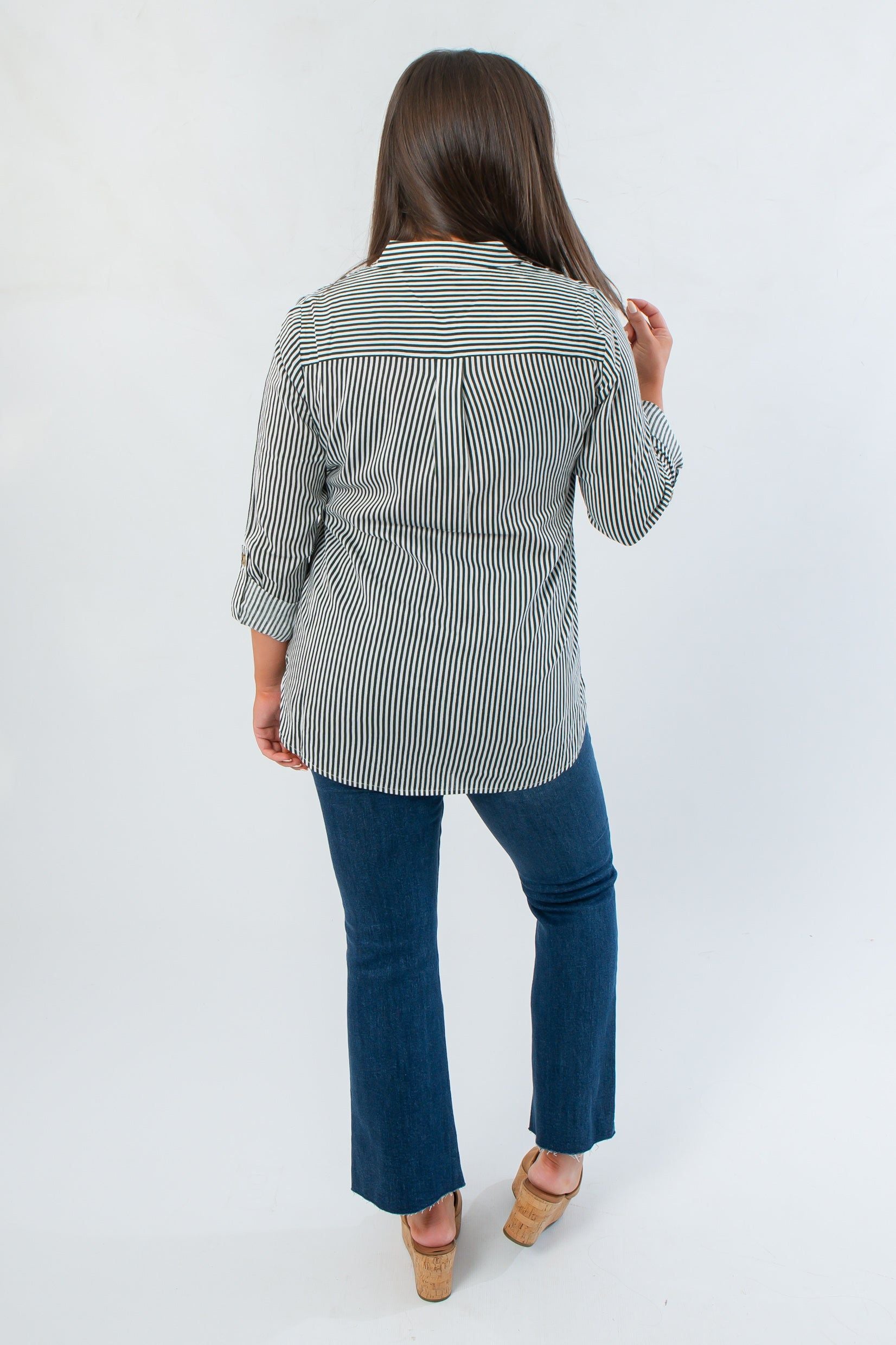 Back view of Dark Green Striped Button Down blouse showing yoke detail and long hem, perfect for stylish fall office wear.