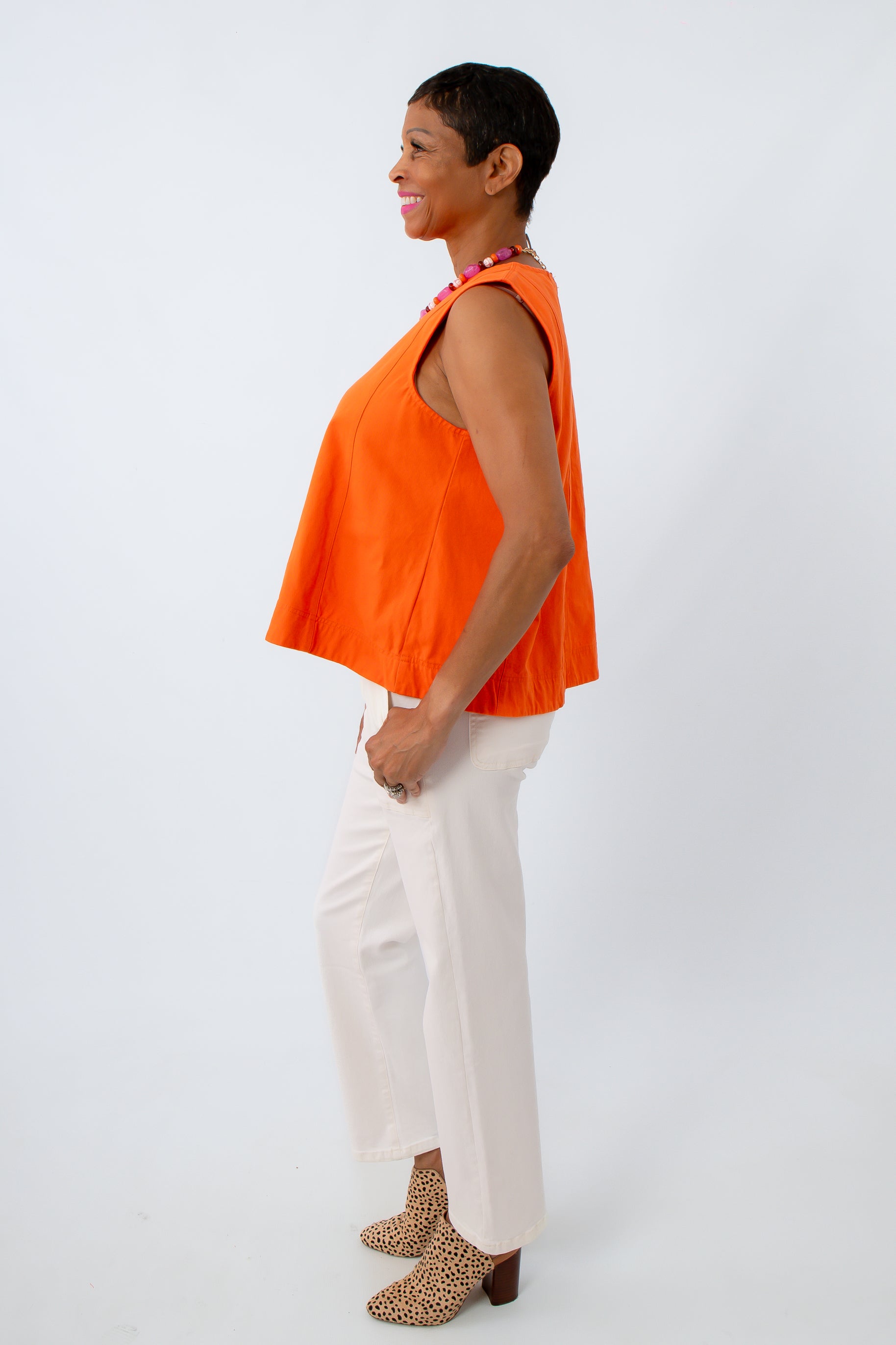 Colored denim tank paired with neutral pants for a fun game day look