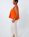 Colored denim tank paired with neutral pants for a fun game day look