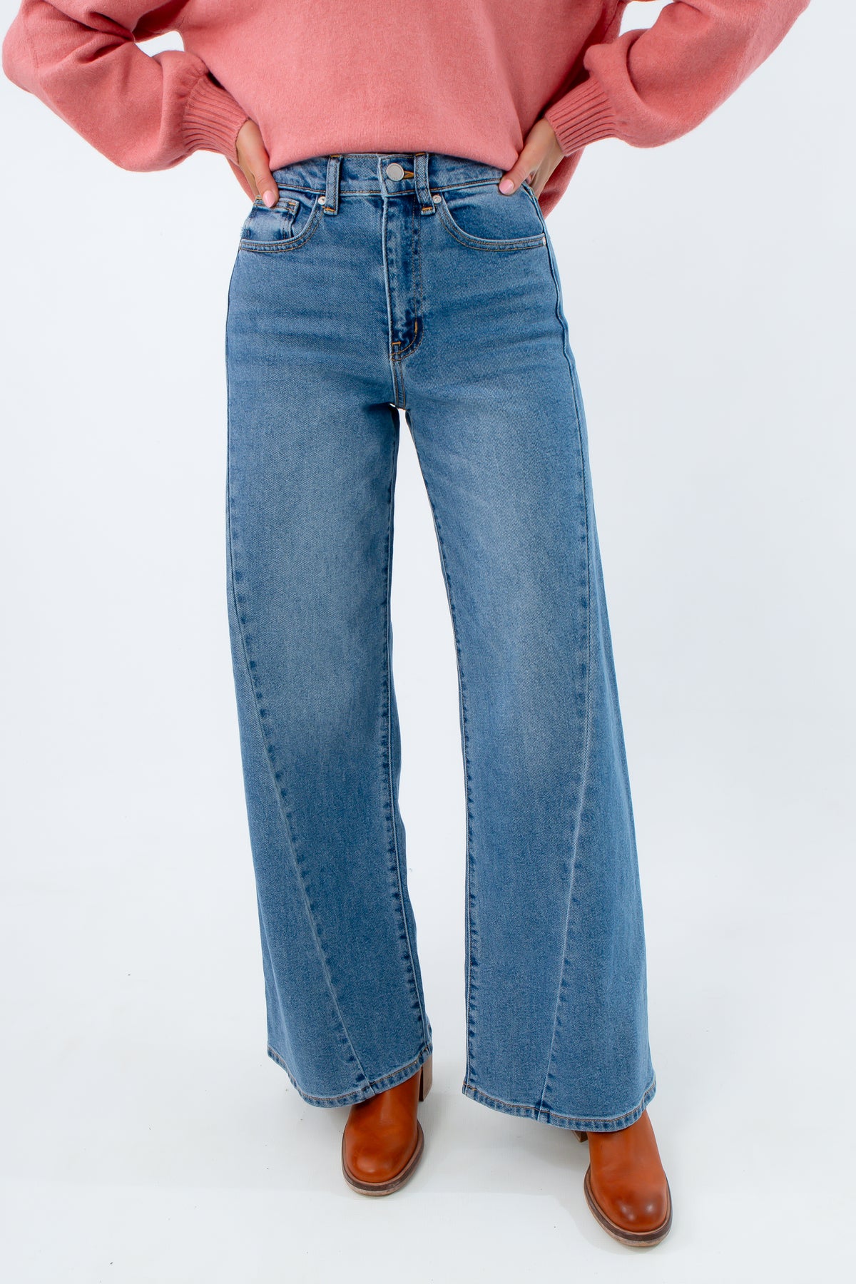 Medium wash high-rise wide leg jeans, jeans with seam detailing, jeans with twisted seam on the sides