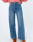 Medium wash high-rise wide leg jeans, jeans with seam detailing, jeans with twisted seam on the sides