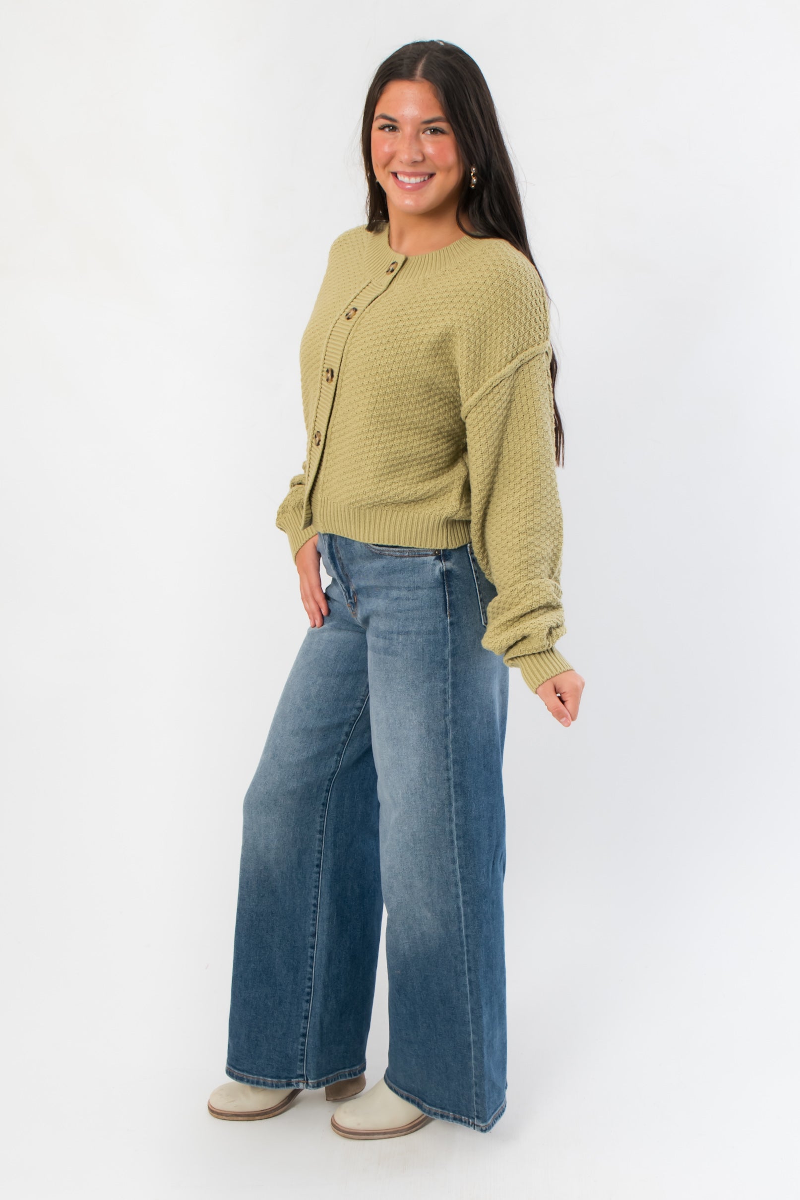 Side view of Free People Whispering Willow Lila Cardigan highlighting its cropped cut and cozy knit texture.