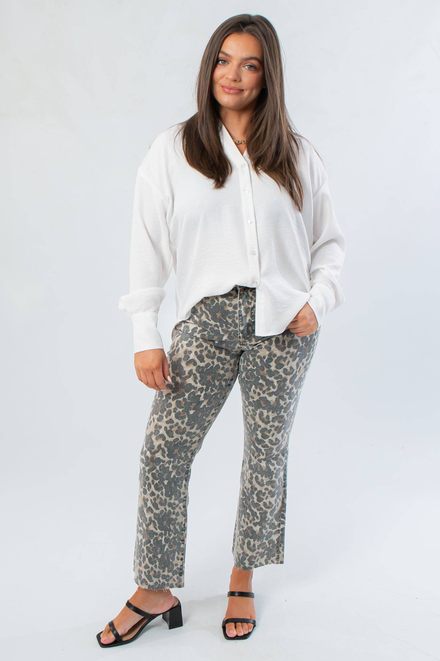 Chic and comfortable Rylee White Oversized Button Down Shirt paired with animal print trousers, ideal for casual or office outfits.
