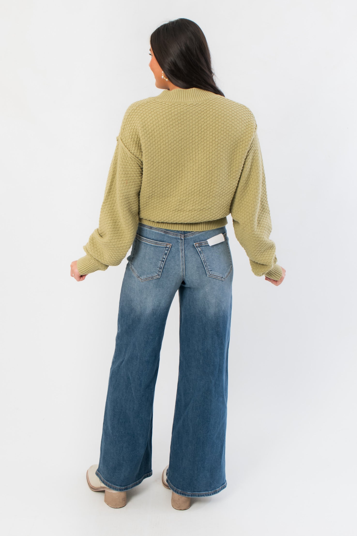 Back view of Free People Whispering Willow Lila Cardigan showing ribbed hem and relaxed silhouette for winter layering.